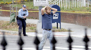 Edgar Maddison Welch, 28 of Salisbury, N.C., surrenders to police Sunday, Dec. 4, 2016, in Washington. Welch, who said he was investigating a conspiracy theory about Hillary Clinton running a child sex ring out of a pizza place, fired an assault rifle inside the restaurant on Sunday injuring no one, police and news reports said. (Sathi Soma via AP)