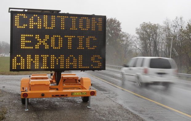 A sign along I-70 warns motorists that exotic animals are on the loose.